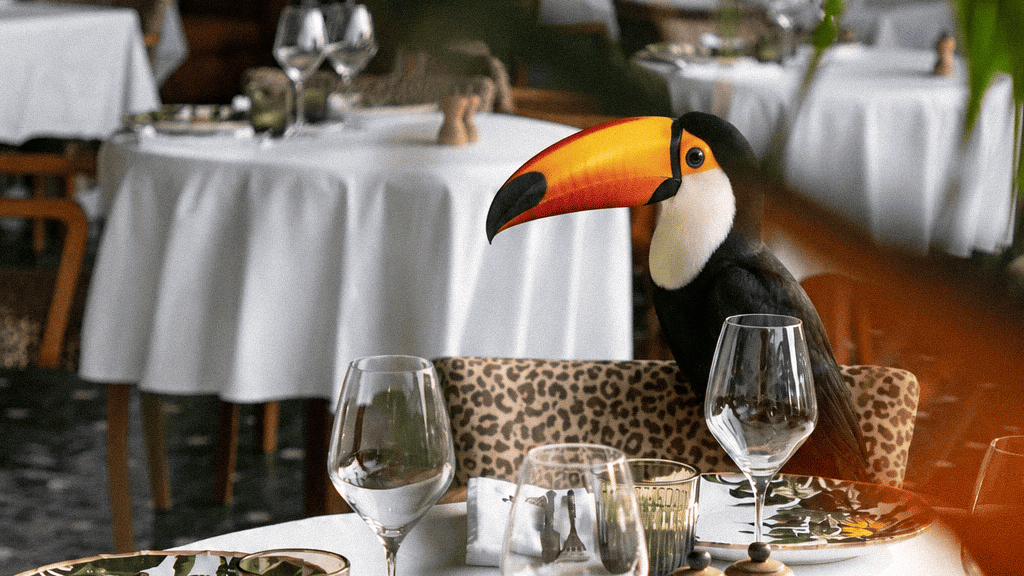 Toucan sitting at a table in a tropical restaurant dining room